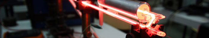 Optically clear adhesive systems for laser applications